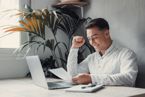 man pumps fist while learning about solvent funding services